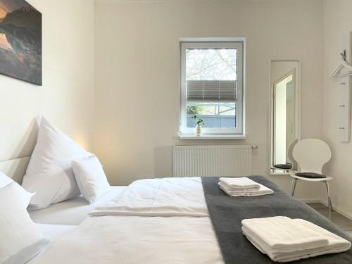 a bedroom with a white bed with two towels on it at Fewo Diemelsee 2 in Heringhausen