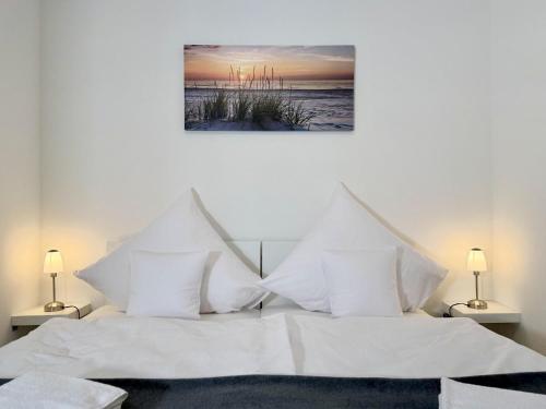 a bedroom with two beds with white pillows at Fewo Diemelsee 1 in Heringhausen
