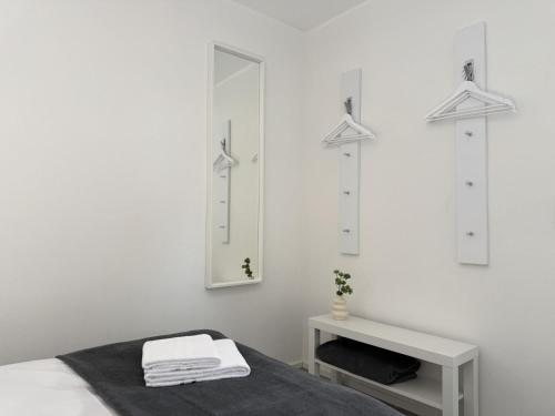 a white room with a bed and a mirror at Fewo Diemelsee 1 in Heringhausen