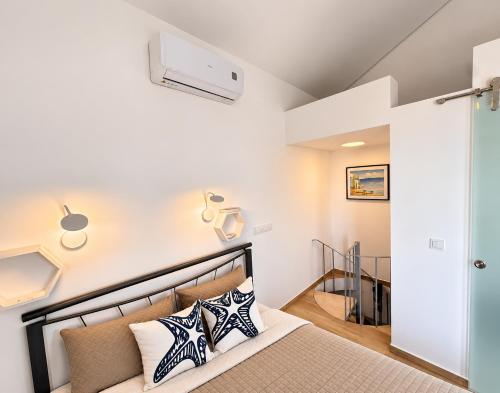a bedroom with a bed and a staircase at Spitaki Almyrida in Almyrida
