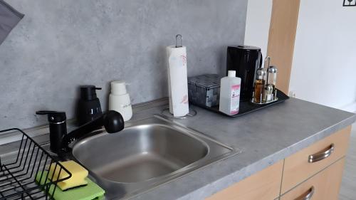 a kitchen counter with a stainless steel sink and a counter top at Ferienwohnung in Naila in Naila