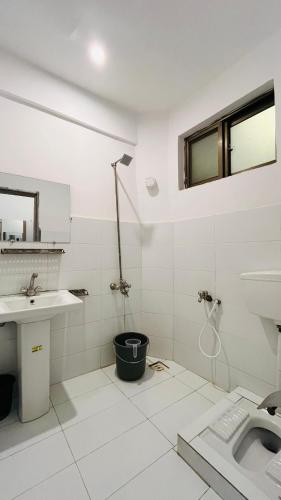 a white bathroom with a sink and a shower at Northview Hotel Hunza in Hunza Valley