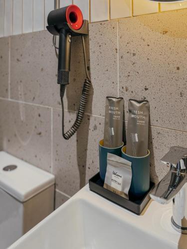 a landline phone sitting on top of a sink at PureJoy Hotel Langkawi in Kuah