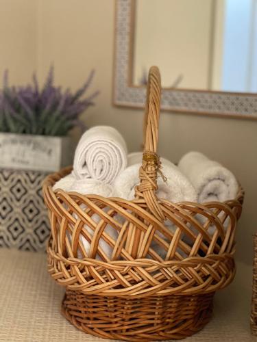 a basket of towels on a table in a bathroom at Victoria City View in Victoria