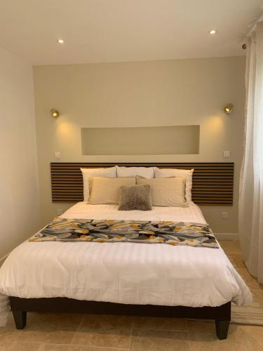 a bedroom with a large bed in a room at La CléryNette in Les Andelys