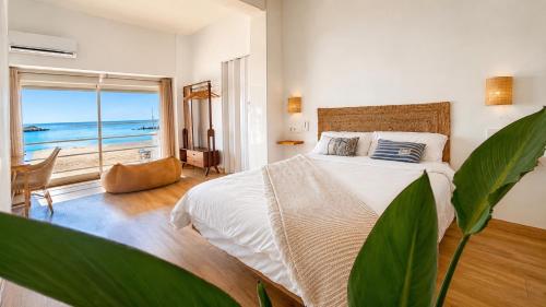 a bedroom with a bed with a view of the ocean at Hostal playa Dreams náutico Adults in Garrucha