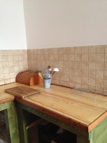 a wooden table with a bucket of utensils on it at Vass Panzio in Zălan