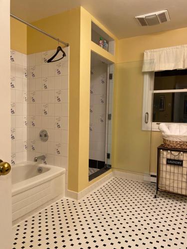 a bathroom with a tub and a tiled floor at Downtown Halifax near waterfront in Halifax