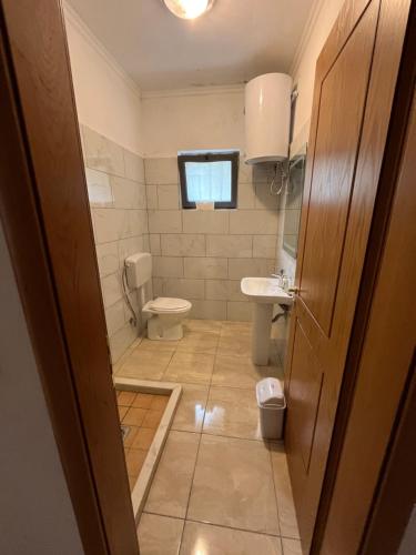 a bathroom with a toilet and a sink at prekal park kamping in Shkodër