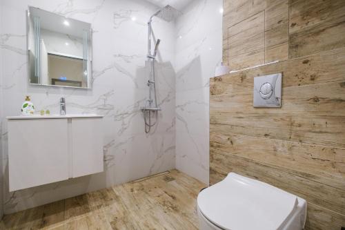 a bathroom with a toilet and a sink at River View 1-Bedroom Apartment in Plovdiv