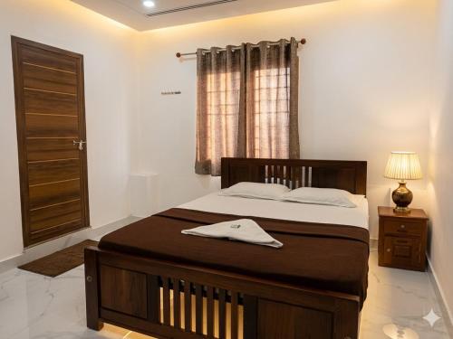 a bedroom with a bed and a window at S P Nettoor in Cochin