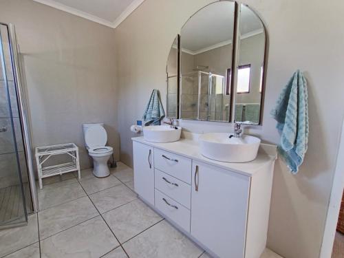 a bathroom with two sinks and a mirror at Valley View the home with a view in Nottingham Road