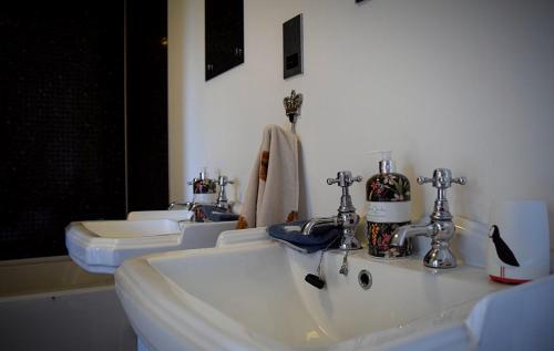 a bathroom with two sinks and two toilets at Benview House in Staffin