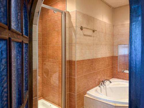 a bathroom with a shower and a tub and a sink at Willa Wypoczynkowa in Międzybrodzie Bialskie