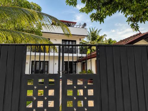 a black gate in front of a house at Janri Villa in Tangalle