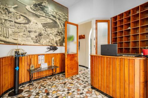 a room with a desk and a laptop on a wall at Hostal Oria in Luarca
