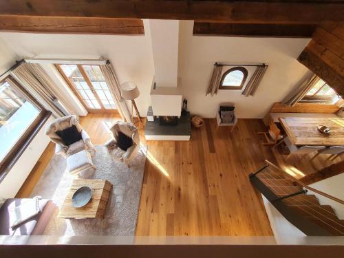 an overhead view of a living room with wood floors at Ferienwohnung Selina in Lenzerheide