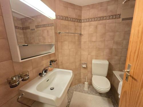 a bathroom with a sink and a toilet at Ferienwohnung Selva in Lenzerheide