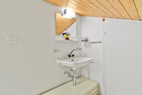 a bathroom with a sink and a mirror at Triangel B Rezia in Parpan