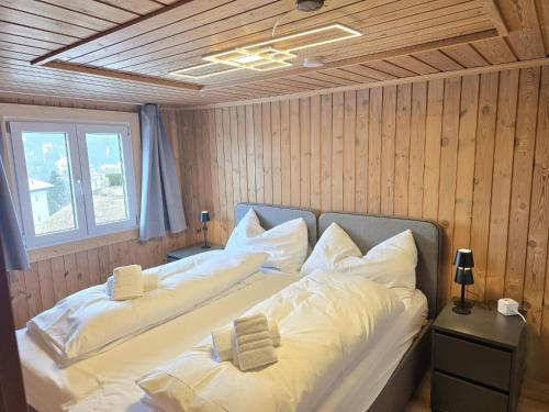 a bedroom with two beds with white pillows at Maiensäss Crapera in Lenzerheide