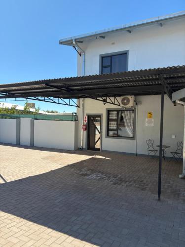 a building with awning and a patio at Pooltjie's Self-catering Overnight in Keetmanshoop