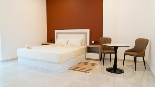 a bedroom with a bed and a table and chairs at A One Resort in Negombo