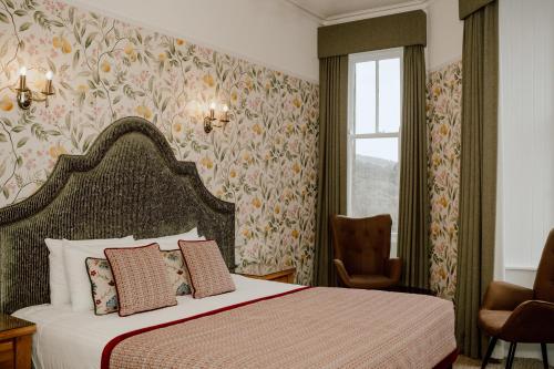 a hotel room with a bed and a window at The Atholl Palace in Pitlochry