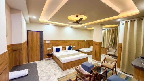 a hotel room with a bed and a couch at Sumitra Enclave in Jaipur