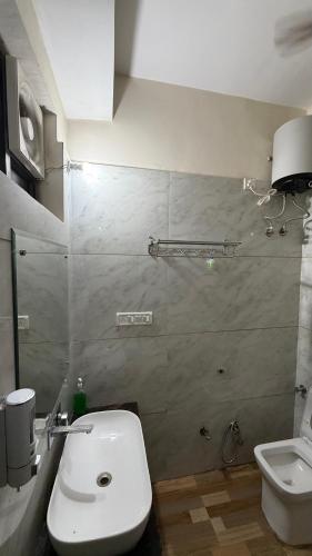a bathroom with a toilet and a sink at Sumitra Enclave in Jaipur