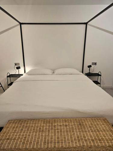 a bedroom with a large white bed in a tent at La Cereria INES in Chiavenna