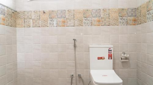 a bathroom with a toilet and a shower at A One Resort in Negombo