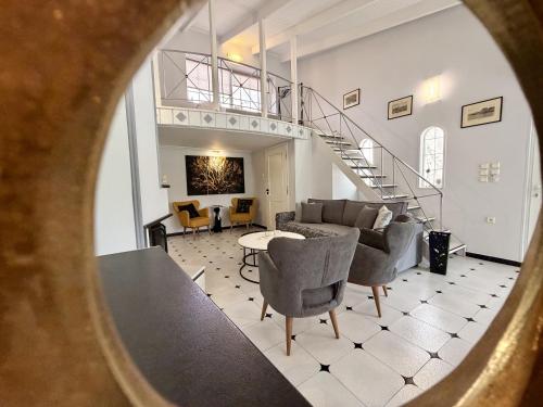 a view of a living room with a spiral staircase at Natalie Apartments Athens Airport in Artemida