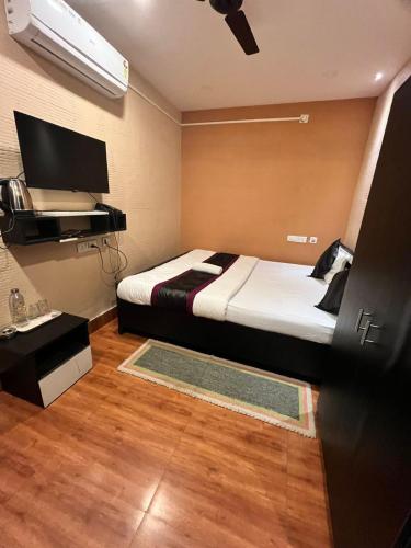 a bedroom with a bed and a tv in it at Meeraj Residency in Mātigara