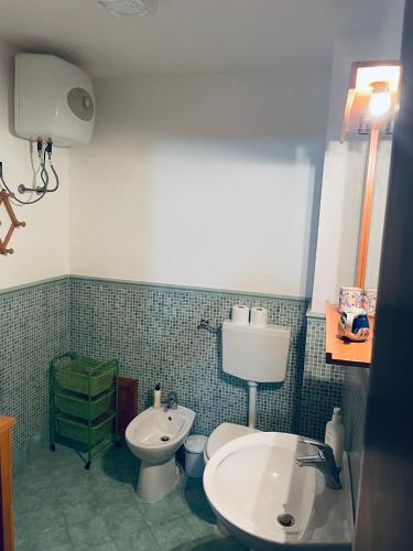 a bathroom with a toilet and a sink at Villa Iovane Diamond in Ustica
