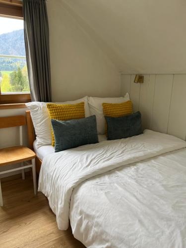 a large bed in a room with a window at Ferienwohnung Gaiswinkler in Grundlsee