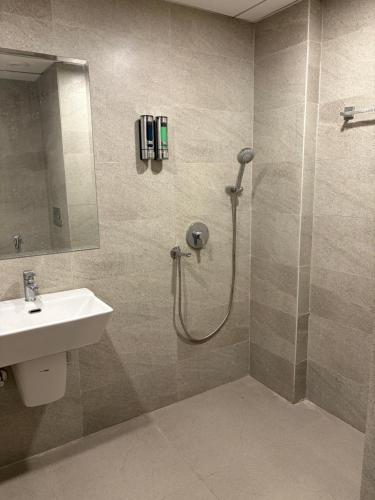 a bathroom with a shower and a sink at The Kaksh in Greater Noida