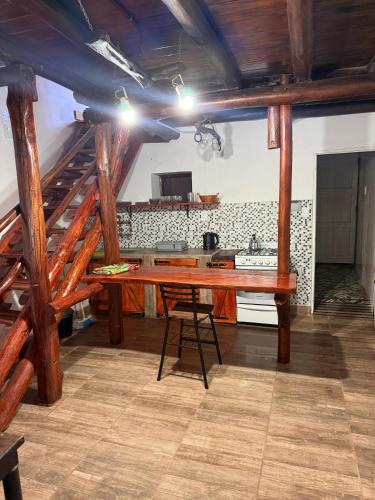 a kitchen with a wooden table in a room at Dulce Claudina 3 in Mercedes