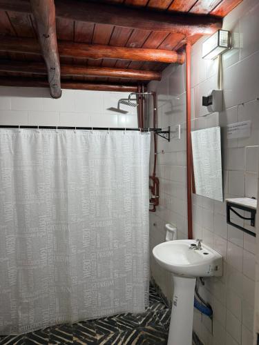 a bathroom with a shower curtain and a sink at Dulce Claudina 3 in Mercedes