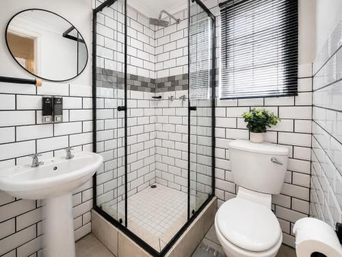 a bathroom with a toilet and a sink at Royal Palms Guest House in Port Elizabeth