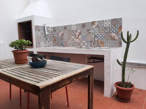 a kitchen with a table and a cactus at Casa MarySol Tamaduste 12m from the Sea, Terrace & BBQ in Tamaduste
