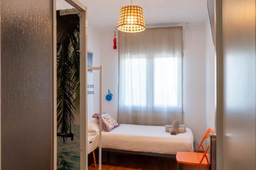 a small bedroom with a bed and a window at Cactus by Arenas in Salinas