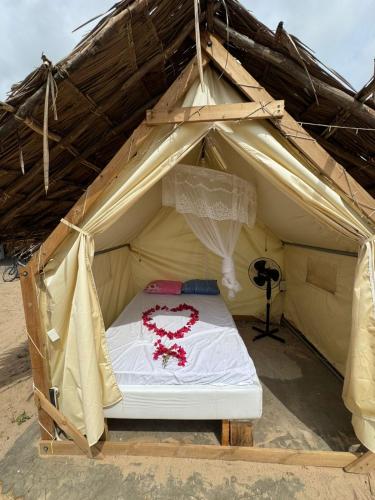 a bed in the middle of a tent at Baba Lao Beach Hostel in Malindi