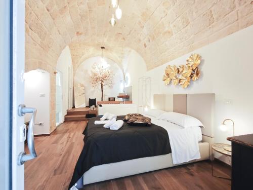 a bedroom with a large bed in a room at Olympus Luxury Suites Menotti in Mola di Bari