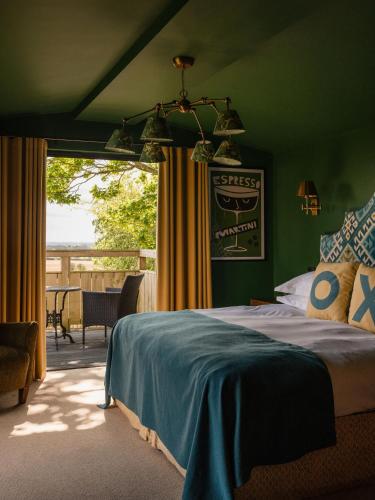 a bedroom with a bed and a view of a patio at The Durham Ox in Crayke