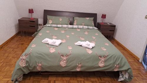 a bedroom with a bed with deer heads on it at Chalet Etna dreamers in Nicolosi
