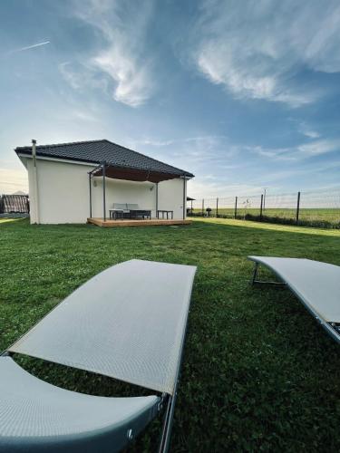 a house with a pavilion and a table in the grass at Villa Alba in Auménancourt-le-Petit