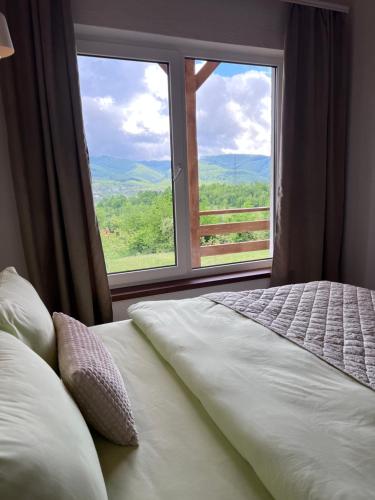 a bedroom with a bed and a large window at Secret place in Svalyava