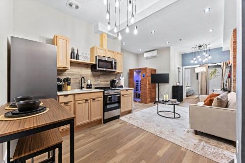 a kitchen and living room with a couch and a table at The West 142nd Street Apartments - Manhattan NYC in New York
