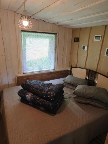 a bedroom with two beds in a room at Sodyba Valdo kubilas in Trakai