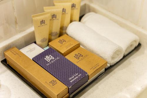 a bunch of towels and towels sitting on a shelf at Majestic Central Hotel in Dubai